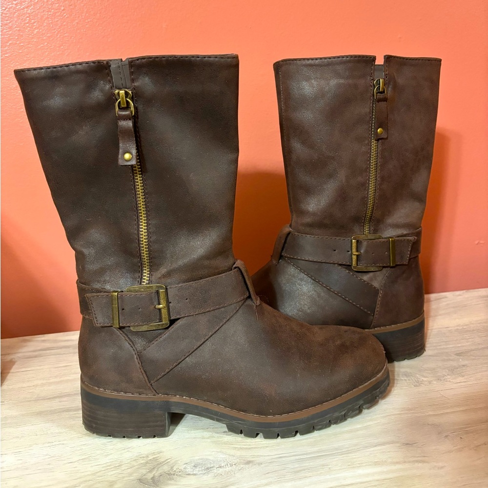 Tall zip-up boots. Small heel. With accent buckle.